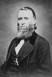 bearded man in Victorian suit