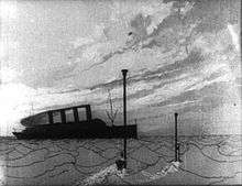 A black-and-white film still.  An ocean scene.  In the distance is an ocean liner.  In the foreground, two periscopes breach the water.