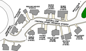 A map of a fictional cul-de-sac showing the locations and numbers of characters' houses, represented by titled oblong gray shapes – five on the top row and five on the bottom row. The titles appear in the order as follows: "GREENBERG HOUSE (#4347)", "SOLIS HOUSE (#4349)", "MULLINS HOUSE (#4351)", "MAYER HOUSE (#4353)" and "SCAVO HOUSE (#4355) on the first row; "HUBER HOUSE (#4350)", "YOUNG HOUSE (#4352)", "VAN DE KAMP HOUSE (#4354)", "DELFINO HOUSE (#4356)" and "McCLUSKEY HOUSE (#4358)" on the second row. On the top row an arrow with the title "BRITT HOUSE (#4362)" indicates a house further up. Between the two rows is a road titled "WISTERIA LANE (COLONIAL STREET, UNIVERSAL STUDIOS)".