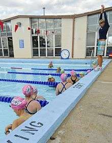 Karlyn Pipes, right, teaches service members and their families freestyle swimming techniques at a clinic on Naval Station in Norfolk, VA in 2011