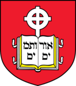Coat of arms of the school, containing a book device inscribed with Hebrew letters and cross in front of a red background