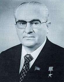 A man in a suit wearing glasses